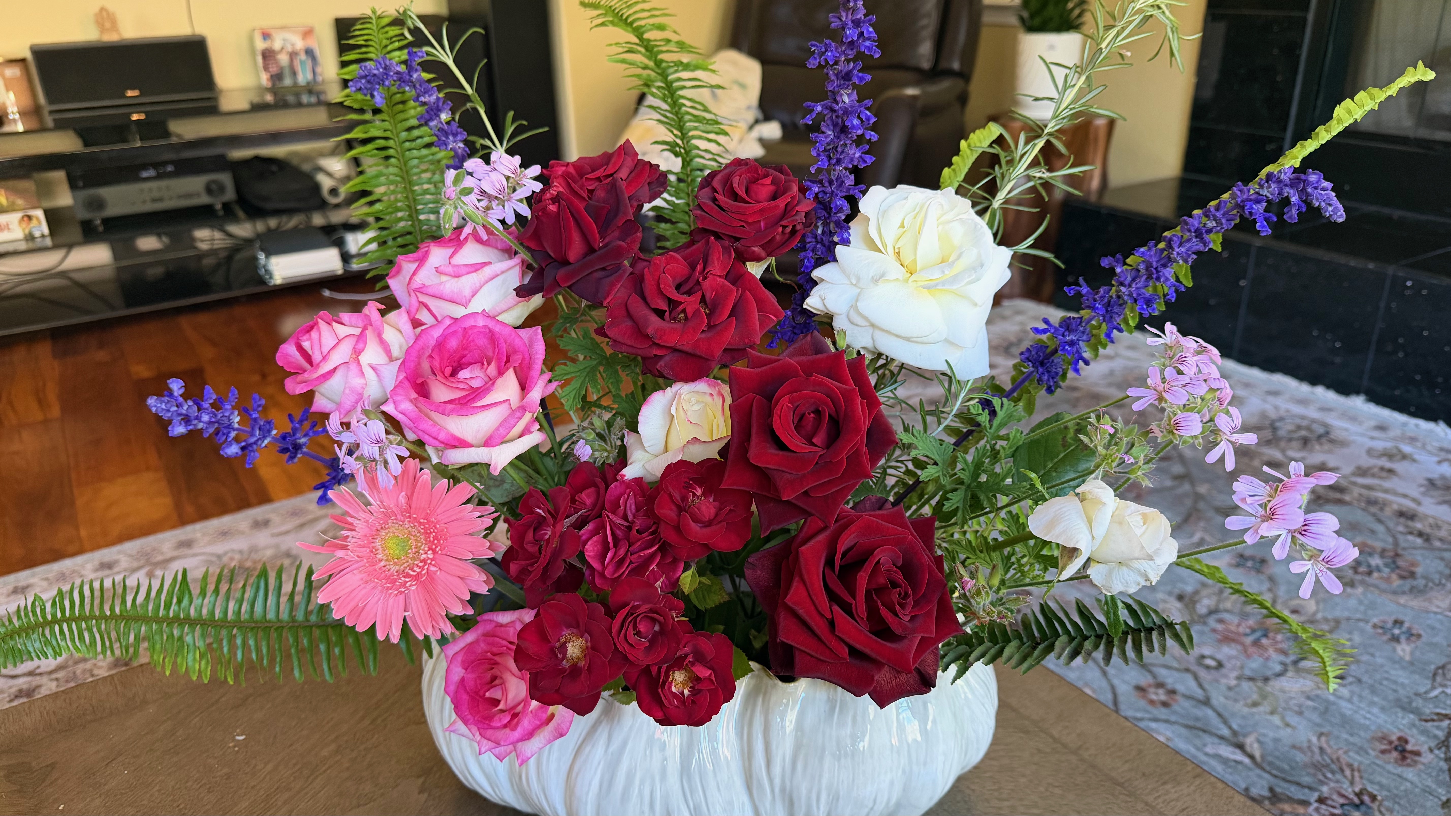 Purple dahlias and gerberas in a blue tray