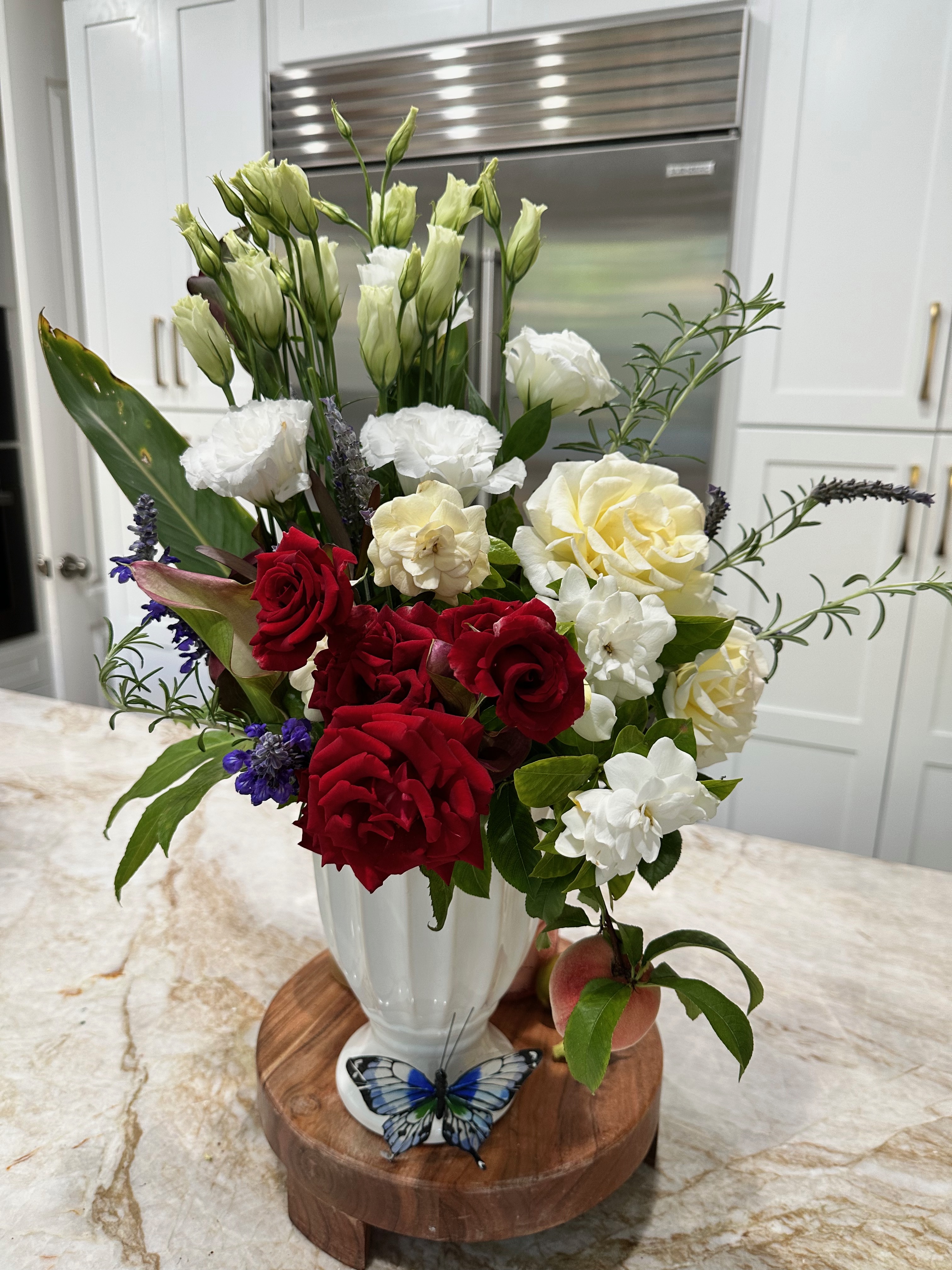 Lush mixed flower arrangement with roses, lilies, and chrysanthemums