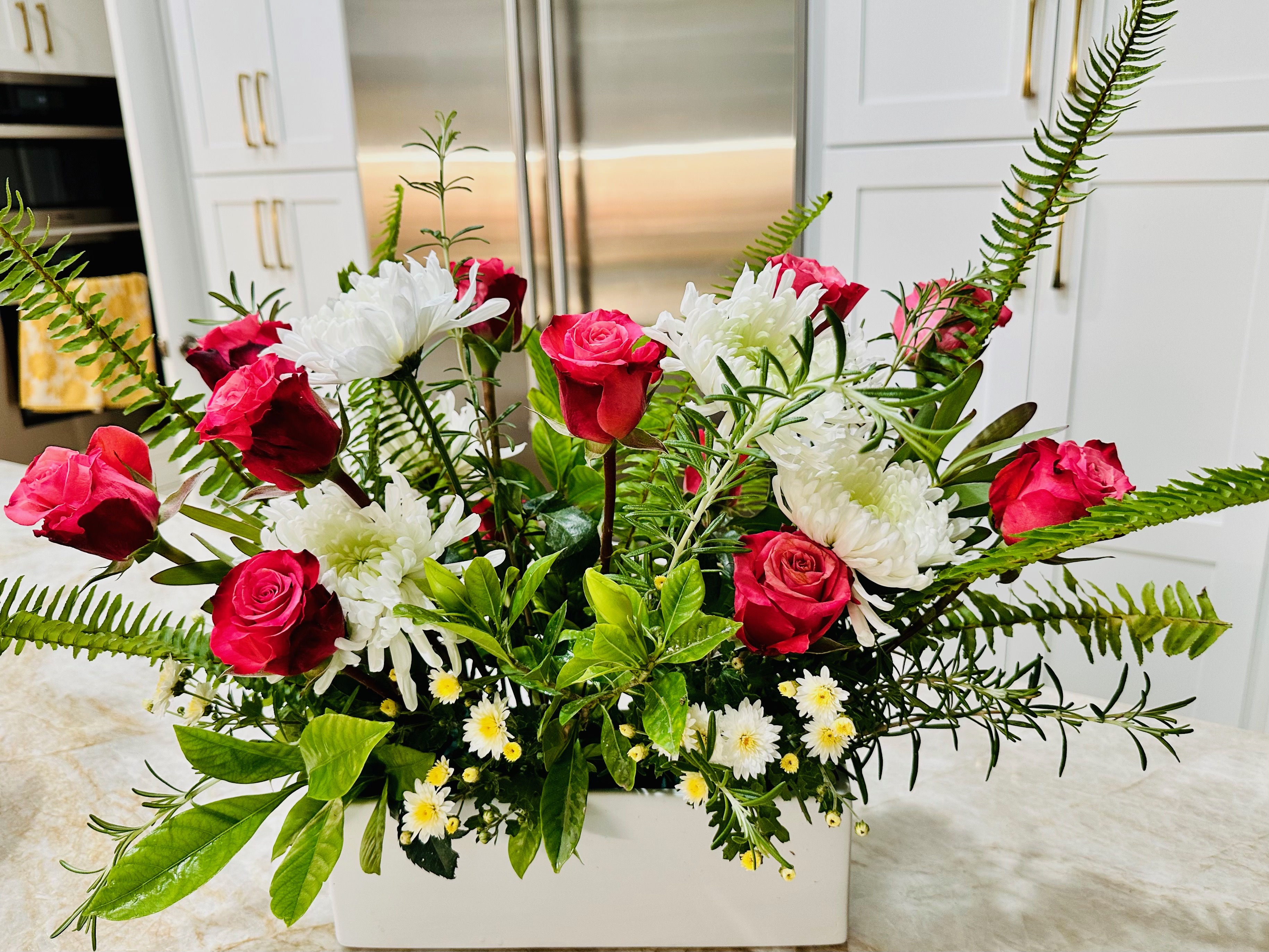 Fuchsia roses and gerberas in a copper bowl